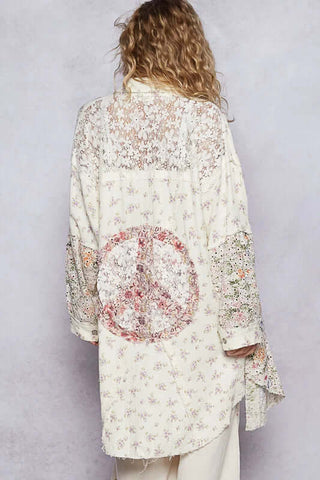 Alt text: "Model wearing POL Ivory & Floral Longline Button-Down Duster, featuring a casual, feminine floral design.
