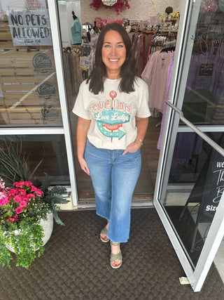 Alt text: "Cupid's Love Lodge Heathered Oatmeal T-shirt with scenic mountain print on soft, comfortable fabric