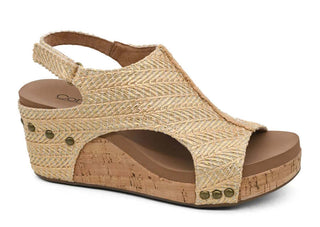 Carley Light Gold Raffia Wedge Sandals with elevated heels and textured straps on a chic pink backdrop.