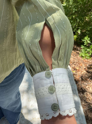 Olive green button-down top with a contrasting collar and a relaxed fit