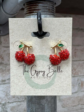 Glamorous Cherry Rhinestone Post Stud Earrings with sparkling red gems and gold-tone leaves on a classy white background.