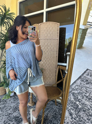 Light blue striped denim shorts with distressed detailing and frayed hem.

