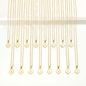 Dainty gold necklace featuring an elegant initial clover pendant, perfect for adding a personalized touch to any outfit.
