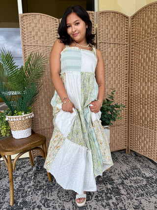 White and green floral patchwork tiered sleeveless maxi dress with ruched bodice.
