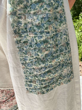 Ivory jogger pants with a floral patchwork design and elastic waistband for a comfortable fit