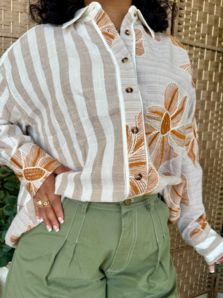Cream and taupe striped button-down top with orange floral print sleeves and front panels.
