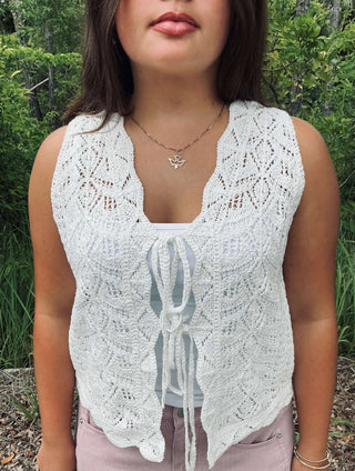 White Polagram crochet vest with tie front, sleeveless design, perfect for layering. Ideal for boho-chic fashion styles.