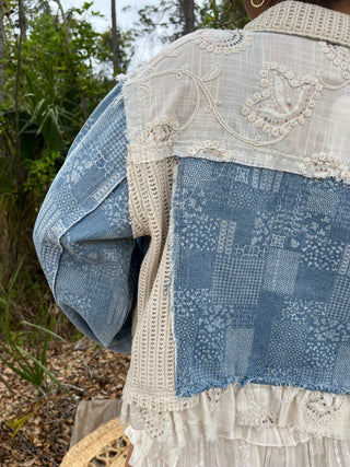 Blue denim bandana jacket with cream embroidered lace trim and sequin details, layered styling.
