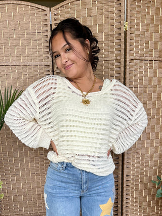 Ivory open-knit slouchy sweater with textured stripe pattern and puffed sleeves.
