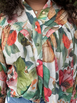 Light yellow button-down blouse with a sunflower print and short sleeves