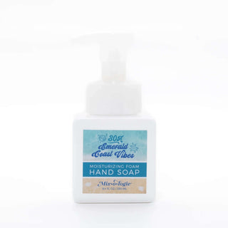 AMI Emerald Coast Mixologie Foaming Hand Soap with refreshing ocean scent in a sleek black pump bottle against a white background.