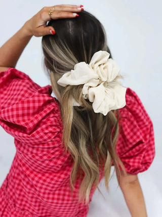 Elegant KAXI oversized scrunchie in luxurious satin finish, perfect for adding a stylish touch to any hairstyle.