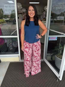 Red paisley print wide-leg pants with side tie detail, FINAL SALE. Perfect for chic and comfortable style.
