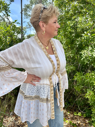 Ivory shell kimono with gold trim and lace inset, worn open over white tank top.
