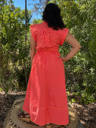 Hot pink and orange striped sleeveless midi dress with tie waist and ruffle shoulders.
