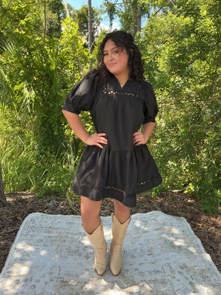 Black short sleeve dress with scallop trim and pockets, perfect for casual or semi-formal occasions