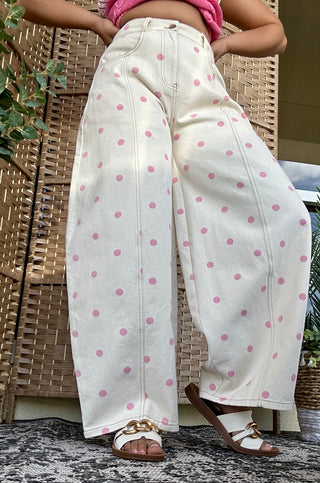 Cream and pink polka dot wide leg jeans with gypsy fit styling.
