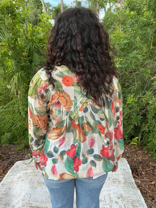Light yellow button-down blouse with a sunflower print and short sleeves