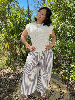 Cream textured short-sleeve tee with blue and white striped jogger pants.
