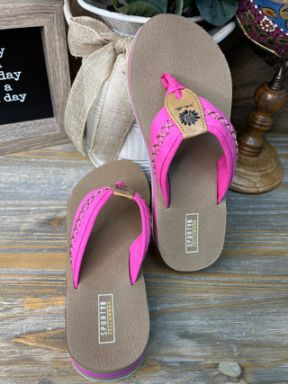 Hot pink and tan flatform sandals with embroidered details and stitched straps on beige suede soles.
