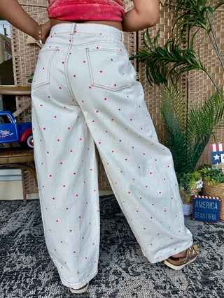 Ivory jeans with red polka dot pattern and gypsy fit silhouette, back view.
