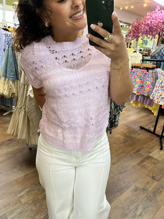 Lilac crochet short-sleeve top with open knit pattern and striped design.
