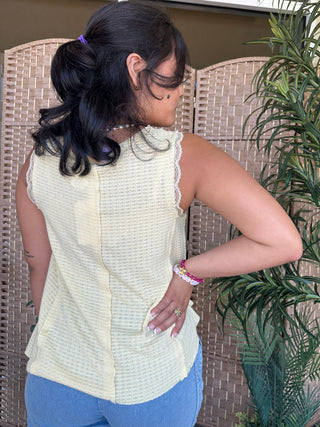 Cream waffle knit sleeveless tank top with lace trim, worn with blue jeans.

