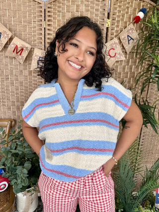 Periwinkle blue, cream, and red striped short-sleeve knit top with V-neckline.
