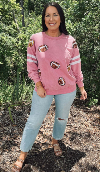 Vibrant hot pink top with dazzling sequin football patches, perfect for game day style and standout fan fashion.