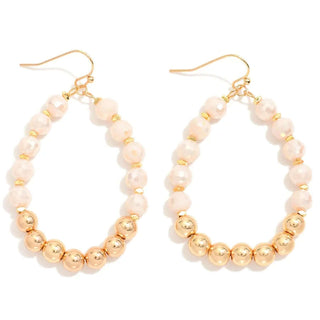 Elegant champagne faceted teardrop earrings with gold beads, perfect for adding a touch of glamour to any outfit.