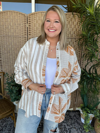 Cream striped button-down top with rust floral print, worn open over lavender tank and distressed jeans.
