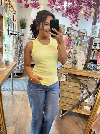 Lemon yellow ribbed knit tank top with crew neckline, sleeveless design.
