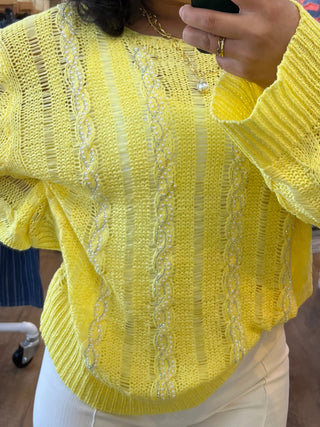 Bright yellow cable knit sweater with cream twisted weave stripes and puffed long sleeves.
