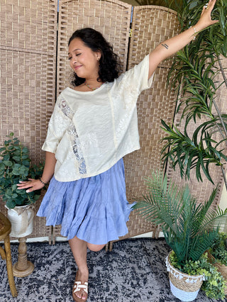 White patchwork lace boho top with three-quarter sleeves and textured details.
