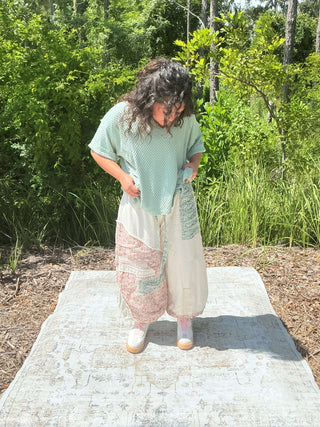 Ivory jogger pants with a floral patchwork design and elastic waistband