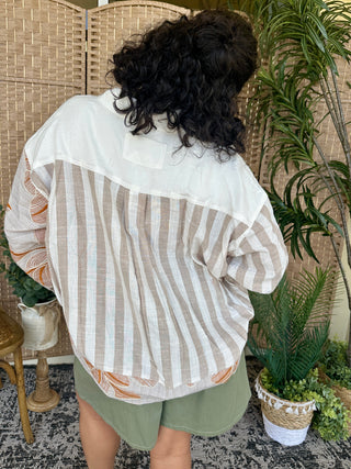 Tan and white striped button-down shirt with white yoke and orange floral sleeves.
