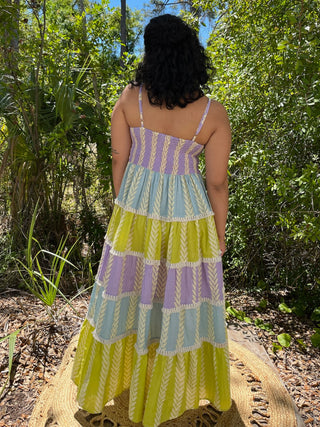 Lavender, blue, and yellow tiered maxi dress with geometric leaf pattern and spaghetti straps.
