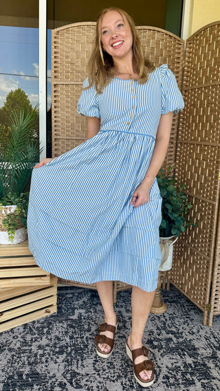 Blue and white striped midi dress with puffed short sleeves and cinched waist.
