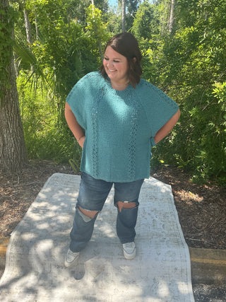 Light gray short sleeve poncho sweater with crochet accents and side ties