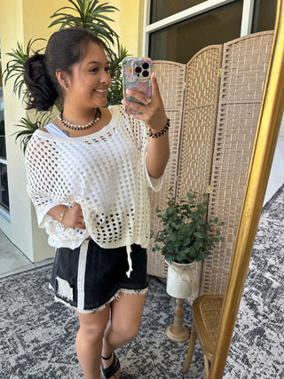 White crochet dolman top with eyelet pattern and short sleeves.
