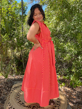 Hot pink and orange striped sleeveless midi dress with tie waist and front pockets.
