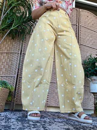 Yellow denim gypsy fit pants with white polka dots and center seam detail.
