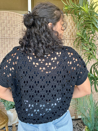 Black open weave crochet short-sleeve sweater with cutout pattern details.
