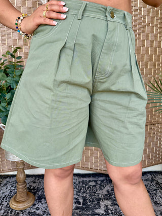 Sage green bermuda shorts with contrast stitching and relaxed fit.
