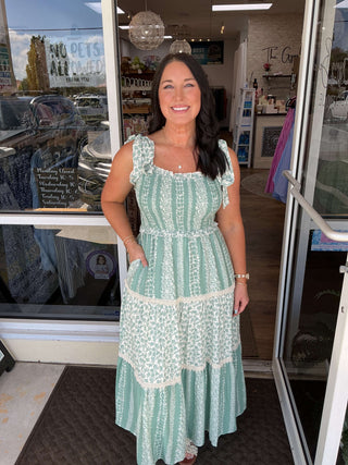 Sage floral Listicle maxi dress with smock tiered ruffle design, featuring flowing sleeves and a relaxed fit.