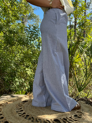 Blue striped wide-leg pants with elastic waist worn with cream ribbed crop top.
