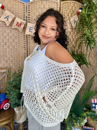 White dolman top with open eyelet pattern and cold-shoulder design.
