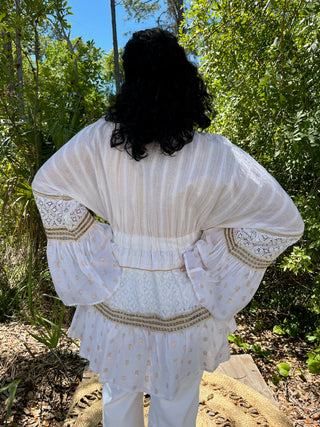 Ivory shell kimono with gold polka dots, pleated bodice, and gold trim detailing on billowing sleeves.
