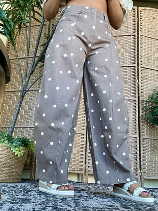 Gray wide-leg jeans with white polka dots, high-waisted fit with button closure.
