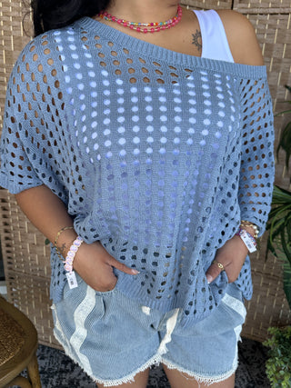 Blue dolman top with allover eyelet pattern and cutout details.
